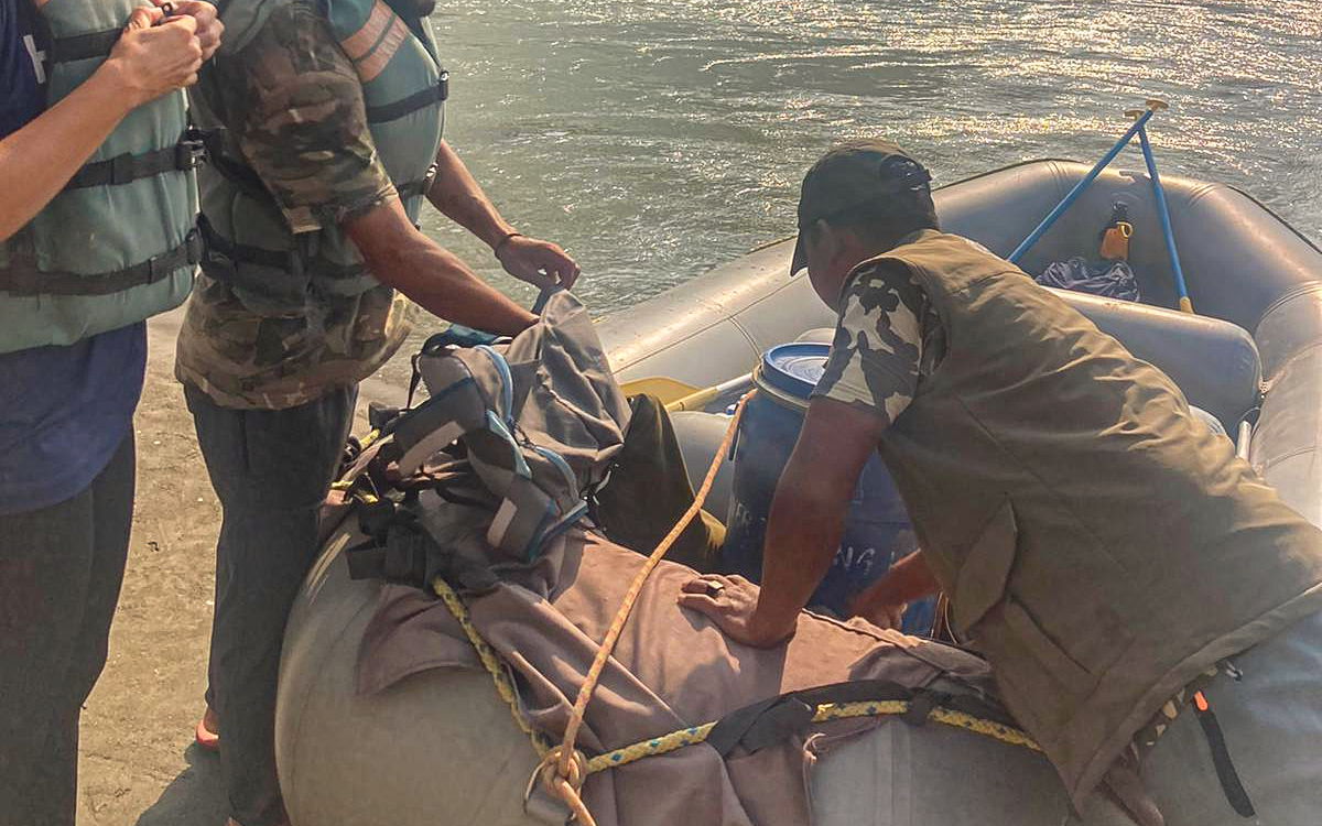people loading a raft on the river